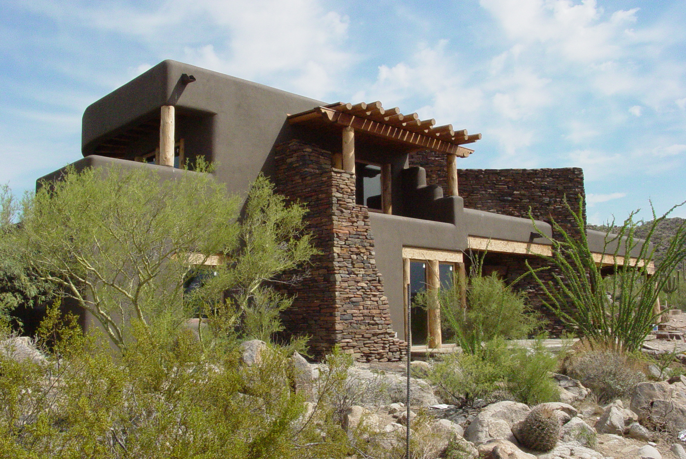 adobe and stone southwestern home exterior image