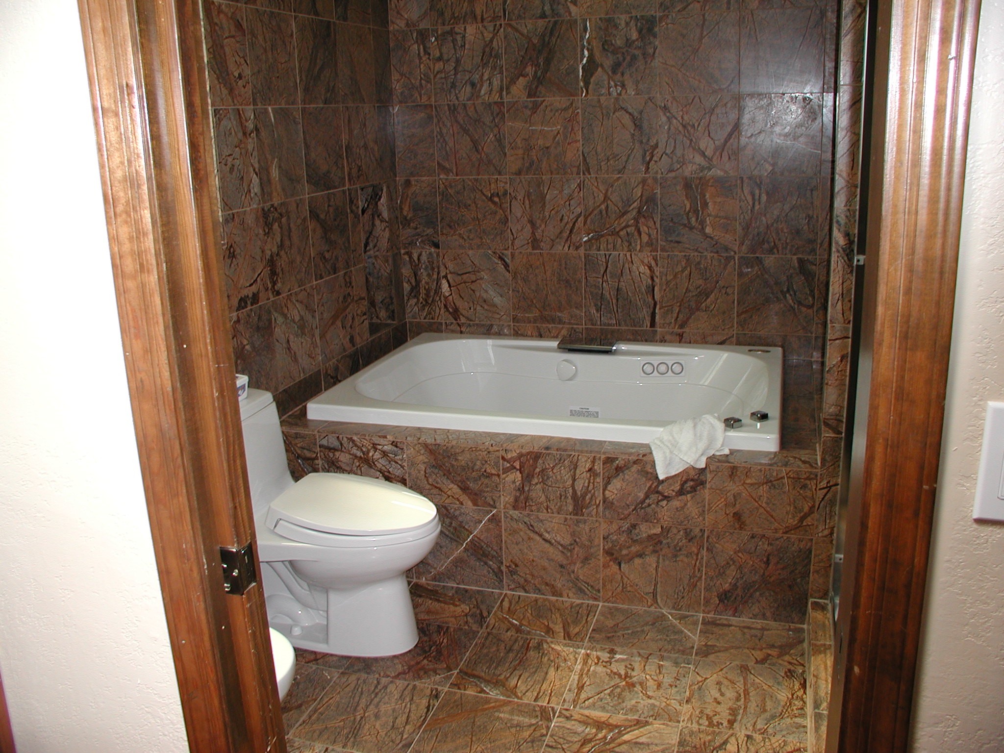 tiled bathtub with toilet image